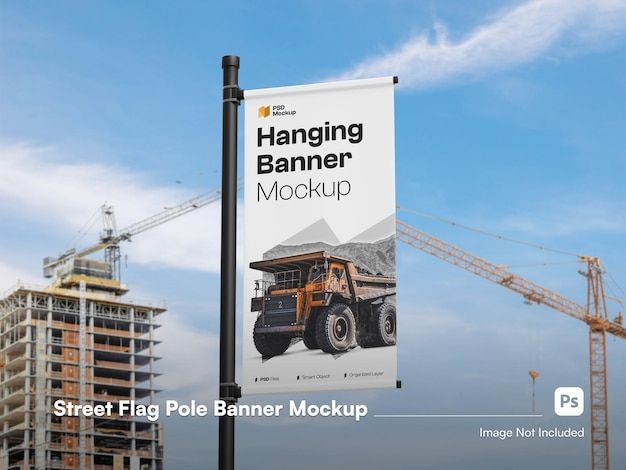 a street sign with the words hanging banner mockup in front of some construction cranes