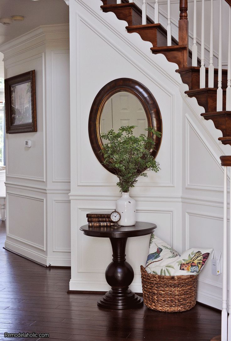 an image of a room with stairs and a mirror on the wall in front of it