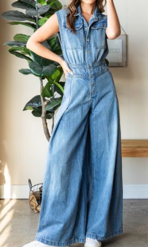 Step into effortless style with the Devin Denim Jumpsuit, featuring a medium-washed denim finish and a chic, sleeveless design. The button-down front and collared neck add a touch of sophistication, while the big cargo chest pocket and back pockets offer practical flair. With a ruched waist back and extra-wide pant legs, this jumpsuit combines comfort and fashion for a versatile, standout look. Measurements (based on flat lay): Small: Chest 17" Waist 14" Hip 21" Length 59" Inseam 31" Medium: Che Casual Full-length Jumpsuits And Rompers For Spring, Medium Wash Full-length Denim Jumpsuit For Spring, Casual Wide Leg Jumpsuits And Rompers With Button Closure, Casual Wide-leg Jumpsuits And Rompers With Button Closure, Medium Wash Full Length Denim Jumpsuit For Spring, Summer Dark Wash Relaxed Fit Denim Vest, Summer Denim Vest In Dark Wash With Relaxed Fit, Medium Wash Sleeveless Denim Jumpsuit For Work, Full Length Medium Wash Denim Jumpsuit For Spring