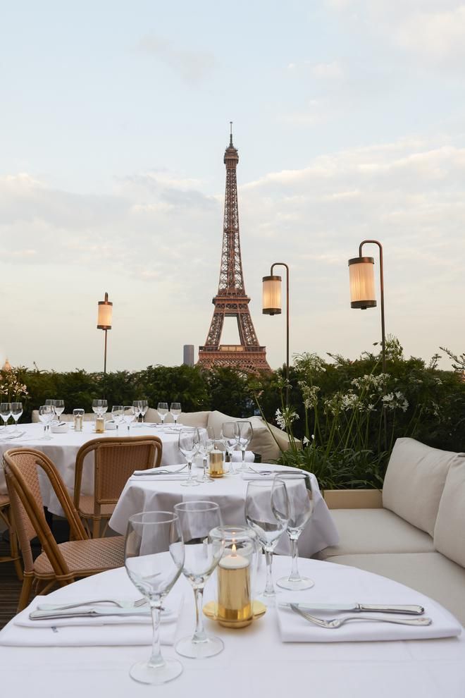 an instagram photo with the eiffel tower in the background and tables set for dinner