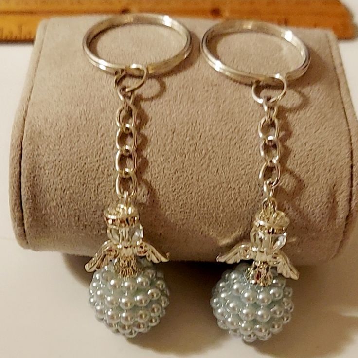 two pairs of earrings are sitting on a bag