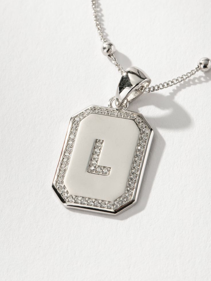 Sur 2.0 Necklace | Sterling Silver L | Product Detail Image | Uncommon James Silver Charm Necklace With Rectangular Pendant And Initials, Silver Initial Necklace With Rectangular Pendant, Silver Initial Pendant Chain Necklace, Silver Pendant Initial Necklace With Delicate Chain, Silver Square Pendant Initial Necklace For Everyday, Silver Initial Necklace With Square Pendant For Everyday, Everyday Silver Initial Necklace With Square Pendant, Silver Chain Necklace With Initial Pendant, Trendy Silver Initial Pendant Necklace