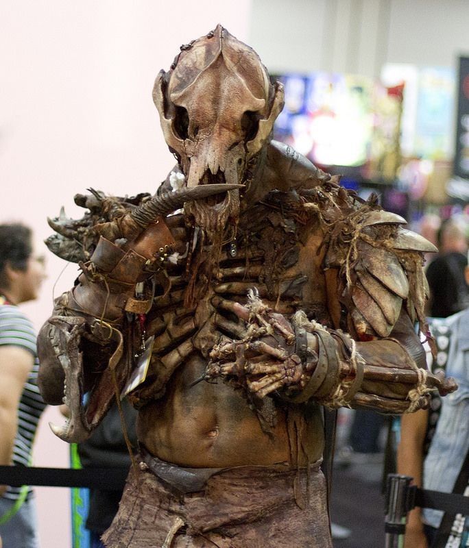 a man dressed up as a creature with lots of flesh on his chest and arms