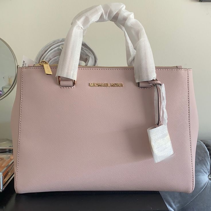 Brand New Never Used Michael Kors Soft Pink Handbag/Satchel. Comes With Strap That Can Convert Purse To Satchel. No Defects. Tag Still Attached. Perfect Condition. Stuffing Still Inside! Michael Kors Classic Satchel For Daily Use, Classic Michael Kors Satchel For Daily Use, Michael Kors Tote Satchel For On-the-go, Michael Kors Satchel For On-the-go, Michael Kors Rectangular Satchel With Handle Drop, Michael Kors Everyday Satchel With Double Handle, Michael Kors Double Handle Satchel For Everyday, Michael Kors Modern Double Handle Satchel, Modern Michael Kors Double Handle Satchel