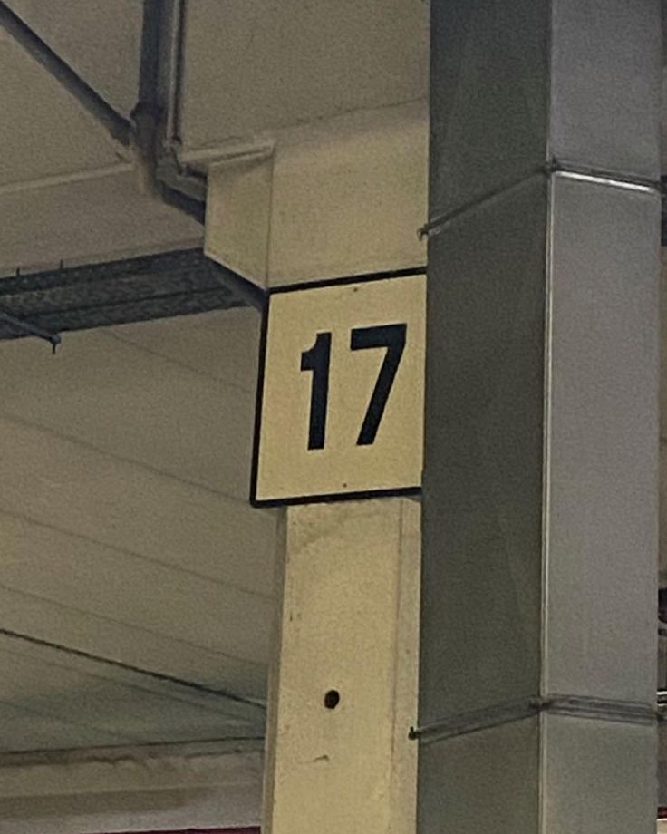 the number 17 is mounted to the side of a building