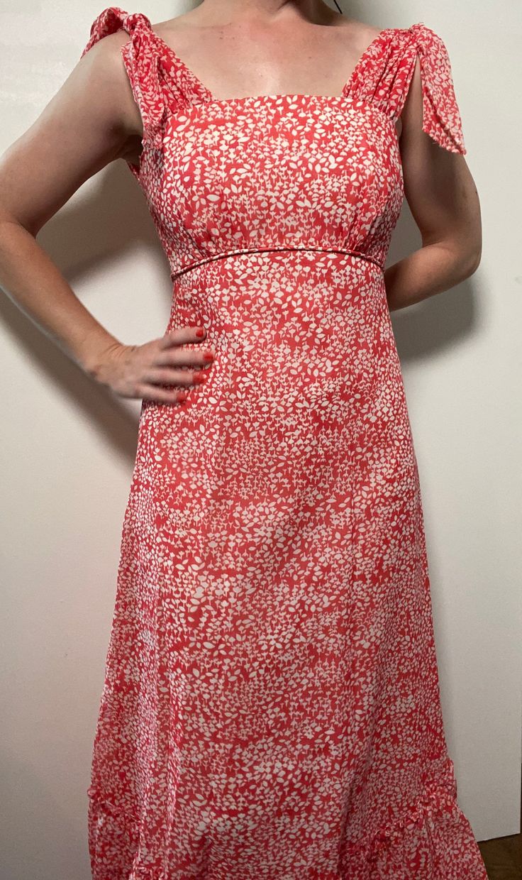 This floral maxi dress is the stuff of dreams! It is Union Made and from the 1970's, made predominantly of cotton and polyester. It's a gorgeous dress and perfect for spring and summer! It is a coral pink color with a white floral pattern on it. It is closest to a modern day size 2/4, but here are the exact measurements taken lying flat and doubled: Shoulders: 15 inches Chest: 28 inches Waist: 24 inches Hips: 30 inches Shoulders to Hem: 50 inches This dress has an inner lining too, so it keeps i Spring Pink A-line Maxi Dress, Red Retro Maxi Dress For Summer, Red Retro Maxi Dress For Spring, Retro Red Maxi Dress For Spring, Spring Lined Empire Waist Maxi Dress, Spring Empire Waist Lined Maxi Dress, Spring Coral Fitted Dress, Spring Sundress Maxi Dress, Spring A-line Orange Maxi Dress