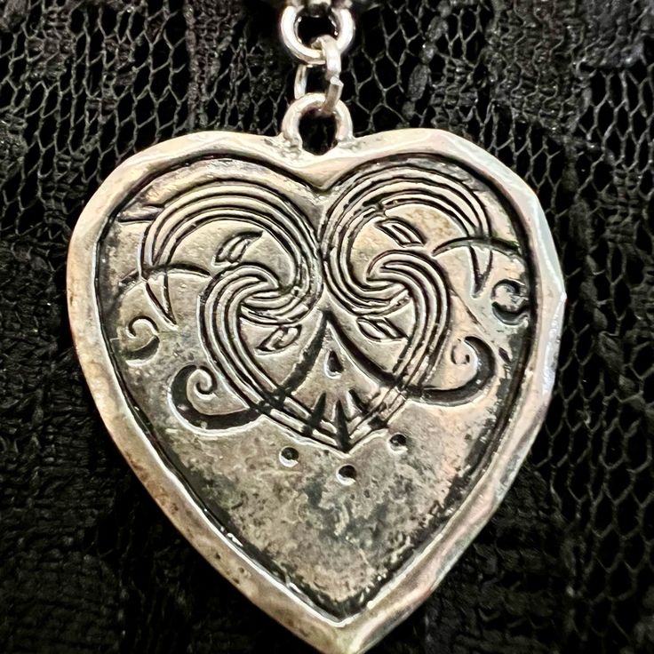 Melancholia Swirly & Silvery Large Distressed Heart Pendant On A Black Corded Necklace. The Cord Measures 17.5” In Length Plus A 2” Chain Extension Topped Off With A Crooked Heart Charm That Will Look Great Dangling Down The Back Of Your Neck. This Piece I Call Melancholia Because It Reminds Me Of A Sad Heart With A Brave Face. Vintage Pendant And Charm. Please Share If You’re Not Interested. Thanks. Nickel Free Heart Shaped Jewelry For Festivals, Nickel-free Heart-shaped Jewelry For Festival, Silver Gothic Heart Charm Necklace, Heart-shaped Metal Necklaces For Festivals, Gothic Silver Heart Charm Necklace, Silver Gothic Heart Necklace, Heart-shaped Metal Necklace For Festival, Heart-shaped Metal Jewelry For Festival, Silver Heart-shaped Jewelry For Festival