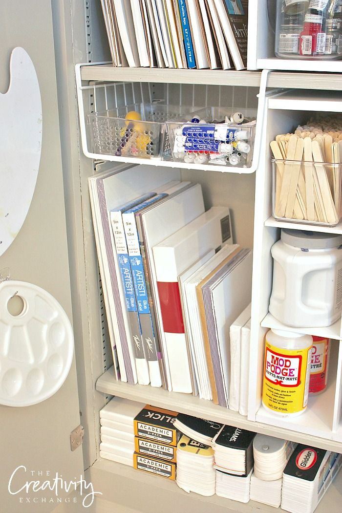 an organized book shelf with books, magazines and other office supplies on it's shelves