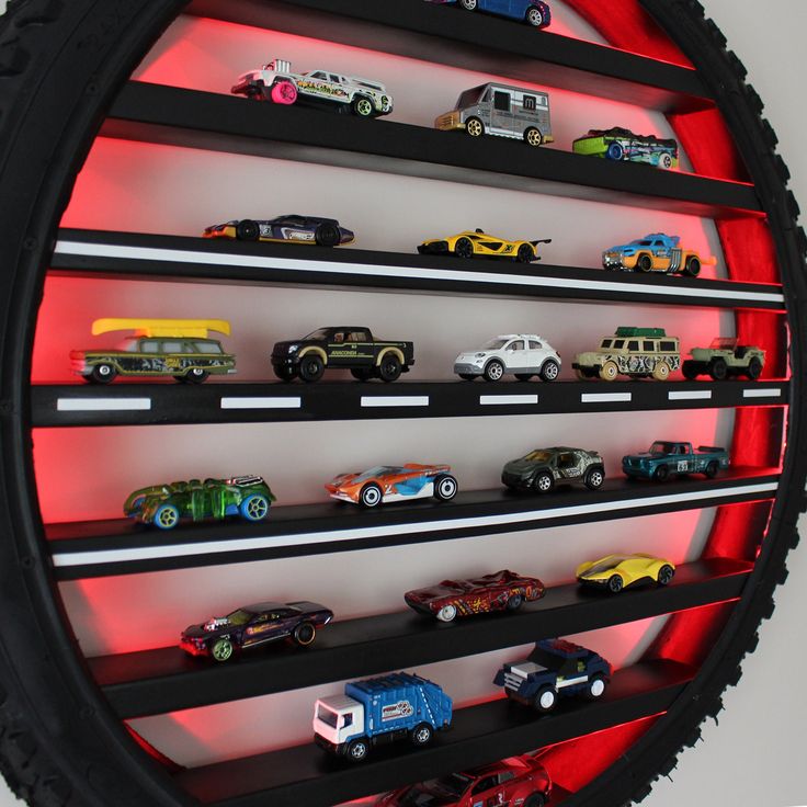 there are many toy cars on the shelves