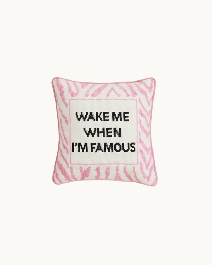 a pink and white pillow with the words wake me when i'm famous on it