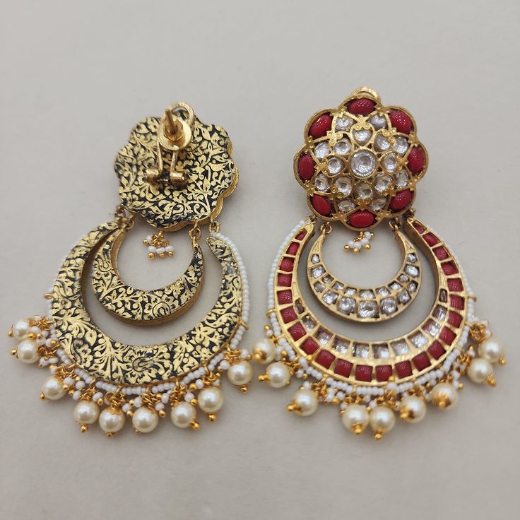 Add a touch of elegance to your look with our Flower Coral Chandbali Earrings. Featuring kundan designs with coral stones, these chandbalis are perfect for enhancing your bridal or festive attire. Their intricate craftsmanship and rich color make them a standout choice for those seeking a blend of tradition and style. Ideal for special occasions, these earrings promise to bring a touch of grace to any outfit. Length: 3" to 3.5" Material: 24Kt gold foil, lac Stones: Kundans, semi precious corals, Festive Attire, Chandbali Earrings, Coral Stone, Pin Pendant, 24kt Gold, Pendant Rings, Natural Beads, Gold Foil, Rich Color