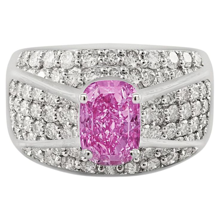 Intricately paired together, this pink sapphire and diamond ring boasts an exceptionally colored oval cut 2 carat Pink Sapphire center stone. Surrounded by a cluster of round cut white diamonds, the ring itself is made from 18k white gold. Dome shank and cluster setting offer excellent coverage on the finger. The Sapphire and diamonds are 100% natural, mined gemstones. Set in 18k solid white gold. Item Details: - Type: Cluster Ring - Metal: 18K White Gold - Weight: 10.4 Grams - Setting: Prong, P Luxury Pink Cluster Diamond Ring, Pink Diamond Sapphire Ring, Gia Certified, Luxury Pink Oval Cluster Ring, Luxury Pink Oval Sapphire Ring, Classic Pink Gia Certified Diamond Ring, Gia Certified Oval Pink Diamond Ring, Pink Diamond Cluster Ring With Accent Stones, Oval Pink Gia Certified Diamond Ring, Luxury Pink Rings With Pave Setting