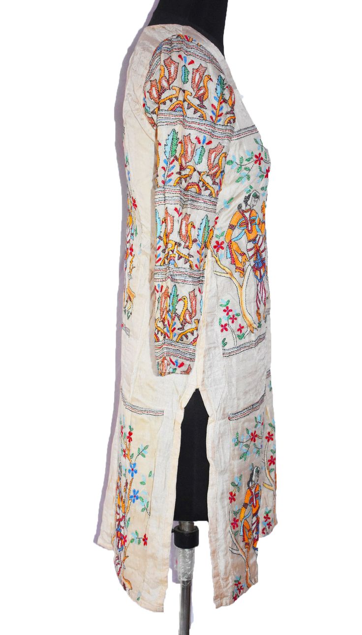 "Item Description Stunning pure silk off white colored hand embroidered kantha long Kurta Top. This dupatta is adorned with beautiful peacock design pink, yellow, green, brown thread work all over done. This stole from Bengal is hand embroidered with the traditional kantha running stitch in a beautiful floral pattern. Specialties :: KANTHA:Kantha is a hand embroidery style traditionally practiced by rural womenfolk in state of West Bengal. Kantha embroidery is recognized by running stitches. The Traditional White Embroidered Dress For Navratri, Traditional White Embroidered Dress For Festivals, White Bohemian Embroidered Dress With Traditional Drape, Long Multicolor Resham Embroidery Kurta, Transitional Chanderi Embroidered Dress, Traditional Raw Silk Embroidered Dress, Traditional Embroidered Raw Silk Dress, Traditional Straight Kurta Embroidered Dress, Chanderi Straight Kurta Embroidered Dress