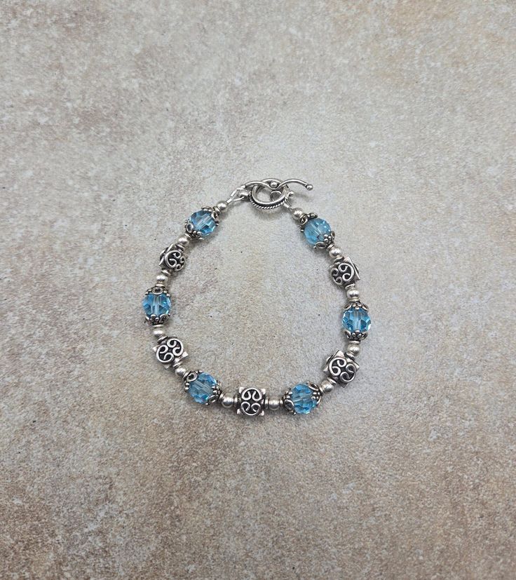 one of a kind sterling bracelet, vintage beaded bracelet, blue Swarovski jewelry Sterling Silver and Swarovski Crystal Handmade Bracelet 7 " all 4mm round beads are sterling silver. All square spacer beads, bead caps and toggle clasp are Bali sterling silver. Swarovski crystals are 8mm round aquamarine Check out my other jewelry at https://loveofjewelryshop.etsy.com *All of my Swarovski crystal bracelets, earrings, and necklaces are my own design using beads I purchased over 20 years ago. Adjustable Blue Crystal Bracelet For Anniversary, Adjustable Blue Bracelets For Anniversary, Sterling Silver Beaded Charm Bracelet Gift, Beaded Sterling Silver Charm Bracelet Gift, Adjustable Blue Birthstone Jewelry, Nickel-free Blue Sterling Silver Charm Bracelet, Adjustable Blue Bracelets With Birthstone, Adjustable Blue Birthstone Bracelets, Adjustable Blue Bracelet With Birthstone