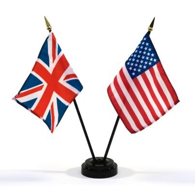 two small american and british flags sitting on top of each other