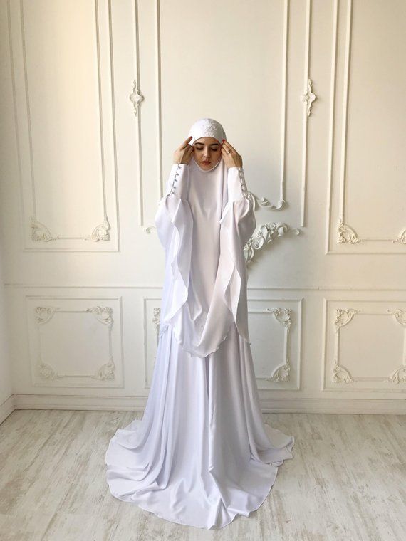 Elegant muslim suit made by soft white color silk. The costume consists of 2 parts of a skirt and a himar, a waist skirt has an elastic band, a lace trimmed with lace, high cuffs with beautiful buttons. On the photo umbrella style skirt, but at variations we also add cheaper variants a flared skirt.We can make different colors. If you want see examples of fabric colors please connect with me!The our goal is to make your image modest, elegant and stylish!Standard skirt length 105 cm, if  you need Dress Nikah, Hijab Stile, Baju Kahwin, Nikah Outfit, Bridal Hijab, Fashion Umbrella, Islamic Dress, Mode Abaya, Muslim Fashion Dress