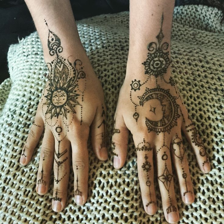 two hands with henna tattoos on them