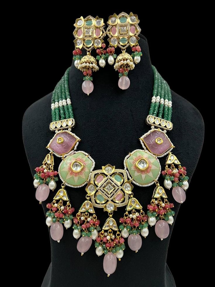 Expertly designed with intricate Meenakari and carving stones, this custom necklace set adds a touch of elegance to any attire. Crafted from high-quality stone, it exudes a regal charm and is sure to make a lasting impression. Elevate your look with this beautifully crafted necklace. Designer Kundan Hand Set Necklaces, Hand Set Kundan Necklaces For Designer Wear, Ceremonial Chandbali Gemstone Jewelry, Designer Wear Chandbali Jewelry With Intricate Design, Ornate Chandbali Jewelry With Stone Work, Ornate Meenakari Pendant Jewelry, Bollywood Style Kundan Gemstone Necklace, Festival Meenakari Pendant Jewelry, Ornate Green Jewelry For Festive Occasions