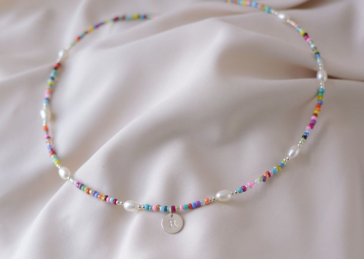 Precious and Colorful Initial Choker Necklace. Perfect as a gift or a beautiful piece to wear in this season of the year    ♡ Beads: Colorful Seed Chaquira.   ♡ High Quality Pearls Grade AAA    ♡ Silver Beads and components: .925 Sterling Silver   ♡ Hypoallergenic   ♡ Long Lasting   ♡ 1in Extender PEARLS: Grade AAA is the Highest Quality of non-round shape pearls.          C A R E ∙ T I P S To maintain the Perfect Quality of your new Velvet Collection Necklace, please: * Wash your necklace with Beaded Chain Strand Beads Gift, Rainbow Letter Beads Necklaces For Summer, Multicolor Tiny Beads Jewelry For Birthday, Beaded Necklaces With Colorful Beads For Birthday, Multicolor Letter Beads Necklace For Gifts, Rainbow Letter Beads Necklace For Summer, Handmade Beaded Strand Necklaces As Gift, Rainbow Colored Letter Beads Necklace For Summer, Handmade Strand Beaded Necklaces As Gift