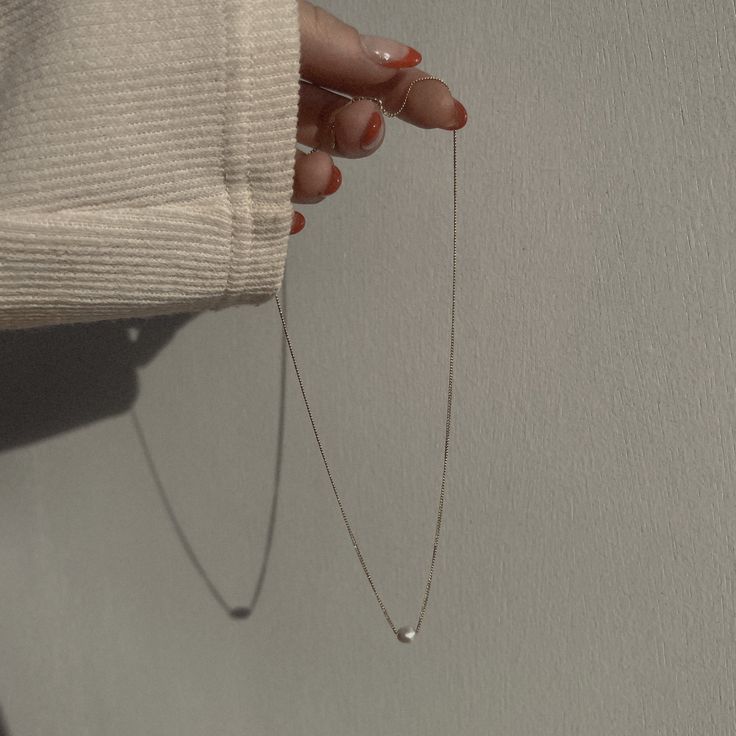 Classic to her core. Delicately strung on a delicate curb link chain, dainty freshwater pearl rests sweetly on the décolleté and is designed to wear with any and everything, all the time. How we style our necklaces: Created to layer with all our pieces, the style-outs are endless and effortless. We love to layer our pendants with our shorties and 20” necklaces. If layering isn’t your thing, no worries! Complete the solo look with a solid wrist stack and a midi ring. Best worn with a glowing smil Minimalist White Chain Necklace For Everyday, Delicate Sterling Silver Chain Necklace For Everyday, Everyday White Gold Necklace With Pearl Charm, White Gold Necklace With Adjustable Chain For Everyday, Everyday White Gold Necklace With Adjustable Chain, Minimalist Pearl Pendant Necklace For Layering, Classic Charm Necklace With Delicate Chain For Everyday, Minimalist Drop Pearl Chain Necklace, Everyday White Gold Pearl Drop Necklaces