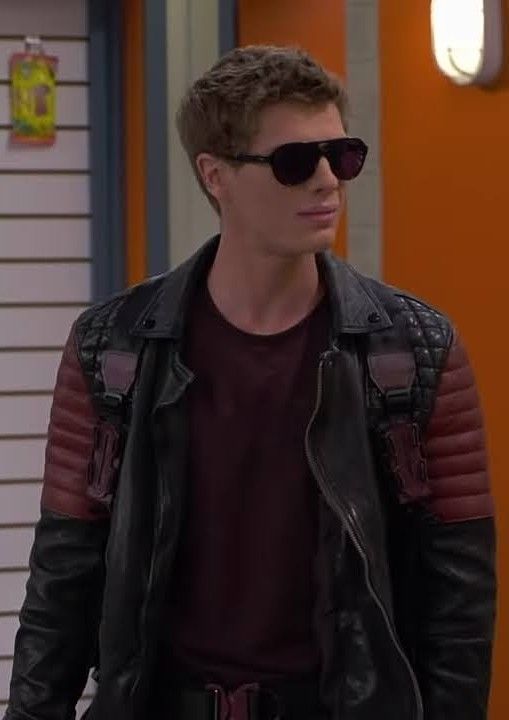 the young man in sunglasses is wearing a leather jacket