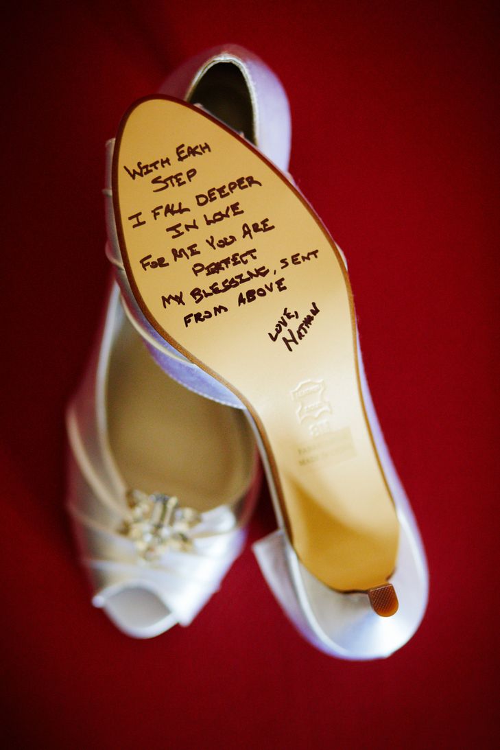 a pair of white shoes with writing on the soles and heels that have been written on them