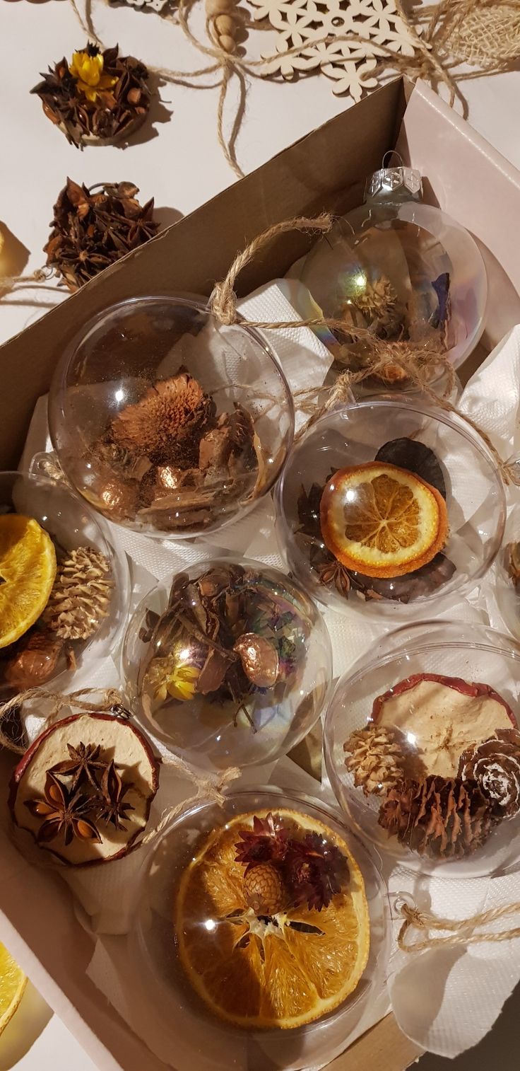 a box filled with lots of different types of fruit inside of glass bowls on top of a table