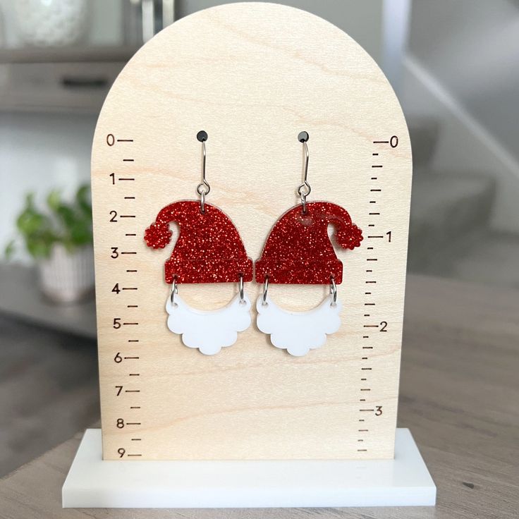 "Sparkly Santa hat dangle earrings are perfect for holiday parties! Earrings are lightweight and great for sensitive ears! 🎄 1.5\" x 1.2\" acrylic beard 🎄 1.7\" x 1.4\"\" acrylic glitter santa hat 🎄 stainless steel ear hooks 🎄 soft plastic earring backs Earrings are gift ready, and come on a card, carefully packaged inside a box. Your gift can be sent directly to the recipient, with a gift message, if desired. PROCESSING / SHIPPING Your order is shipped within 2-3 business days from order da Santa Earrings Diy, Holiday Party Earrings, Plastic Earrings, Earrings Christmas, Holiday Earring, Party Earrings, Soft Plastic, Gift Message, Christmas Earrings