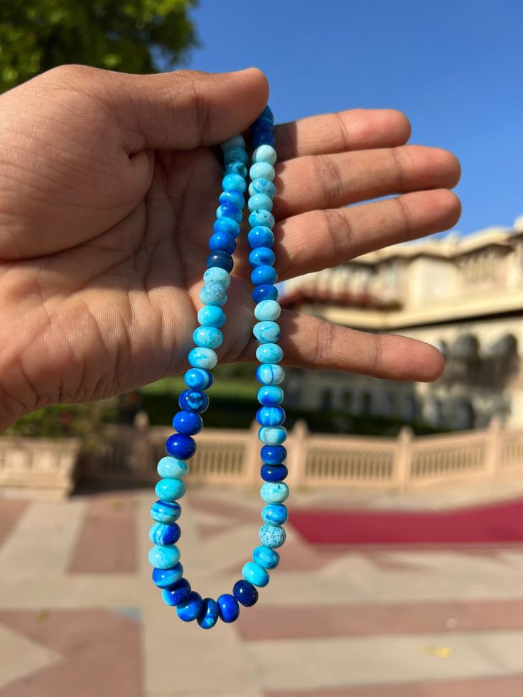 Natural Shade Blue  Round Shape Smooth Opal Beads Necklace ,7-10 mm Opal Beads, 16 Inch Strands Necklace AAA+ Quality. Gemstone  :    Opal. Color           :    Shade Blue. Size             :     7-10 mm size. Shape         :    Round Smooth Shape. Style           :    Smooth Handmade Beads.  Quality       :    AAA+ Length       :    16''  Strand.  For   :   Necklace, Jewelry Design, Craft Making, Gift, Etc.   These Are Natural Gemstones Therefore, Variation In The Shade & Quality Is Expected. Gemstone Picture Shown Are Of Actual Gemstone That You Will Receive, However, The Color & Appearance May Look Slightly Different Depending On Your Monitor Resolution & Climatic Condition. Some Imperfections Can Be Expected As Stones Are Natural. If Required, Please Ask Us To Show The Lot Image Before Hand-strung Blue Beaded Bracelets With Round Beads, Blue Hand-strung Beads For Jewelry Making, Hand-strung Blue Beaded Bracelets, Blue Spiritual Beads With Colorful Details, Blue Rondelle Beaded Bracelets With Polished Beads, Bohemian Hand-strung Blue Beads, Blue Polished Beads For Beach, Blue Rondelle Gemstone Beaded Bracelets, Blue Rondelle Beads