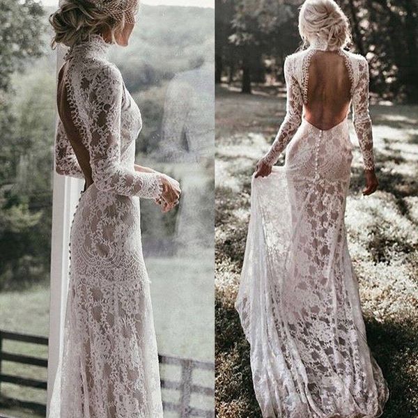 the back of a woman's wedding dress in front of a window and outside