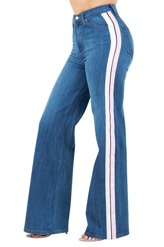 Add a playful touch to your wardrobe with our Striped Wide Leg Pants! Made in the USA, these high rise jeans feature a wide leg fit, front button and zipper closure, and front and back pockets. The Pink and White side stripes add a chic twist to the classic medium wash denim. Stand out from the crowd with this unique and stylish piece!33" Inseam Length 11.5" RiseMade in USA Style: high rise Silhouette: wide leg Embellishment: side stripes Length: full length Closure: zipper, button Made In: USAF Trendy Wide Leg Bottoms With Vertical Stripes, Striped Mid-rise Denim Jeans, Trendy Denim Bottoms With Vertical Stripes, Spring Bottoms With Contrast Stripes And Straight Leg, Denim Wide Leg Bottoms With Vertical Stripes, Wide Leg Denim Bottoms With Vertical Stripes, Casual Vertical Stripes Denim Jeans, Casual High Rise Jeans With Vertical Stripes, Casual Wide Leg Jeans With Vertical Stripes