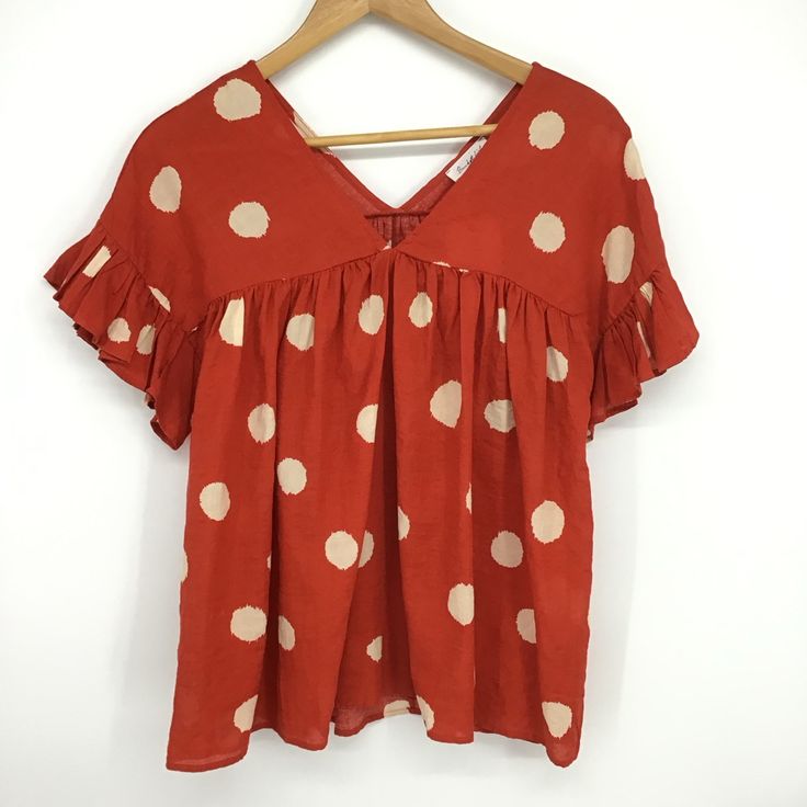 Buck List Polka Dot Print Ruffled Baby Doll Top. Size Medium V-Neck Ruffled Sleeves Slouchy Fit Lightweight Material Style # T1347b Color: Burnt Orange With Cream Dots Dropped Dolman Shoulder Condition: New With Tag B0225 Cute V-neck Blouse For Vacation, Orange Short Sleeve Blouse With Ruffles, Orange Ruffled Short Sleeve Blouse, Casual Swiss Dot V-neck Blouse, Orange Ruffled Tops For Vacation, Casual V-neck Swiss Dot Blouse, Casual V-neck Top With Swiss Dot Details, Cute V-neck Blouse For The Beach, Cute V-neck Blouse For Beach