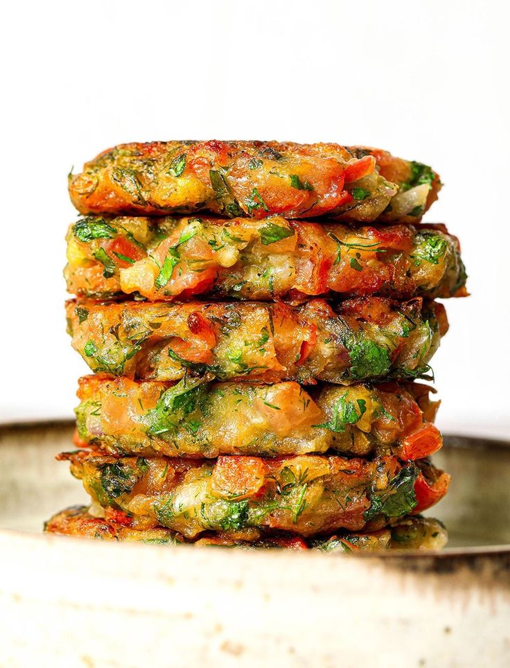 a stack of vegetable fritters sitting on top of a metal pan