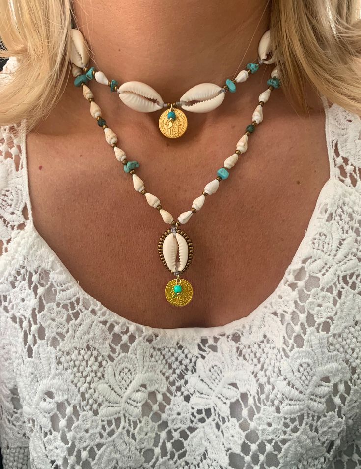 These stunning shell neckleces are meticulously crafted from shells & sea life findings collected along the sun-kissed beaches of the Cycladisc Islands of Greece.   ▽▲Details▽▲ ⭐Natural Cowrie & cone snail shells collected from Greek sea ⭐Turquoise round beads & chips  ⭐inoxidable brass elements ⭐mineral graphite beads (tarnish free) ⭐Clever fastening to secure perfect fit ⭐Adjustable length ⭐Allergy free/Nickel free ⭐Waterproof use ⭐Handmade excellency In 2 styles: a. Choker necklace made from Cheap Handmade Shell Beaded Necklaces, Beach Shell Necklace Made Of Mother Of Pearl, White Shell Charm Necklaces For The Beach, Summer Shell Strand Jewelry, Beachy Shell Necklaces For Summer, Beachy Shell Necklace For Festival Season, Bohemian Strand Jewelry For Summer, Bohemian Jewelry For Beach Vacation, Bohemian Beach Jewelry For Vacation