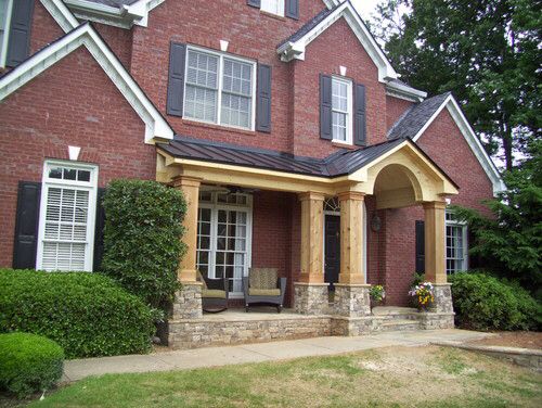 a brick house with black shutters and white trim