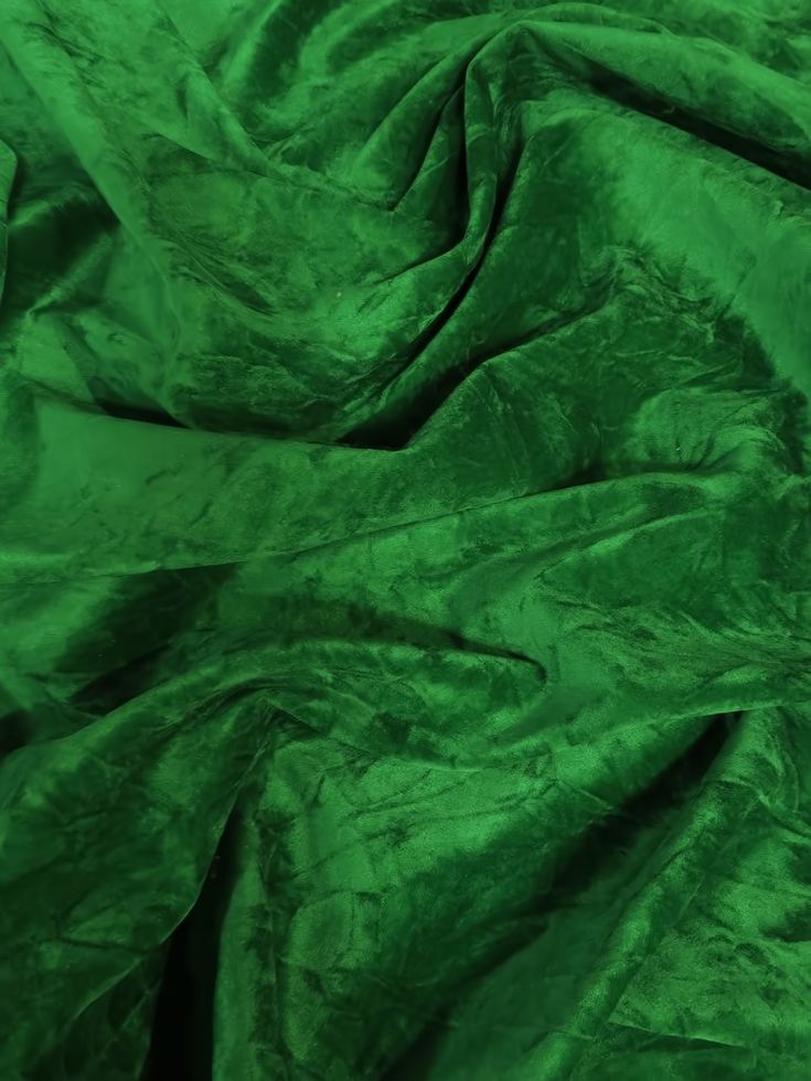 the green fabric is very soft and shiny with it's folds down to reveal an interesting pattern