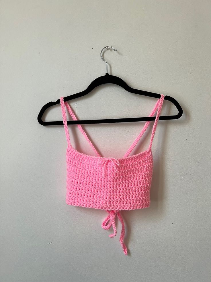 Available in white and pink! The back of this top is adjustable, so it can fit a range of sizes, but works best for a size medium. Pink Cropped Tops For Spring, Pink Cropped Top For Vacation, Pink Cropped Tops For Beach, Pink Cropped Vacation Top, Fitted Pink Crochet Crop Top, Pink Stretch Summer Tank Top, Pink Stretch Tank Top For Summer, Pink Crop Top For Beach, Pink Fitted Crop Top Tank