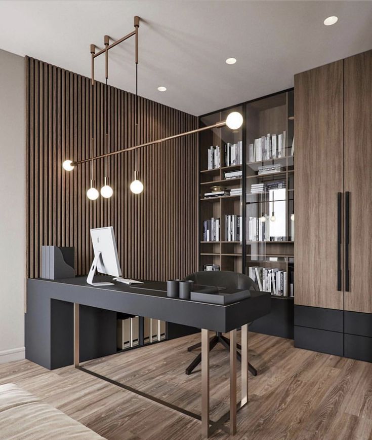 an office desk in front of a bookcase with bookshelves and lights on it