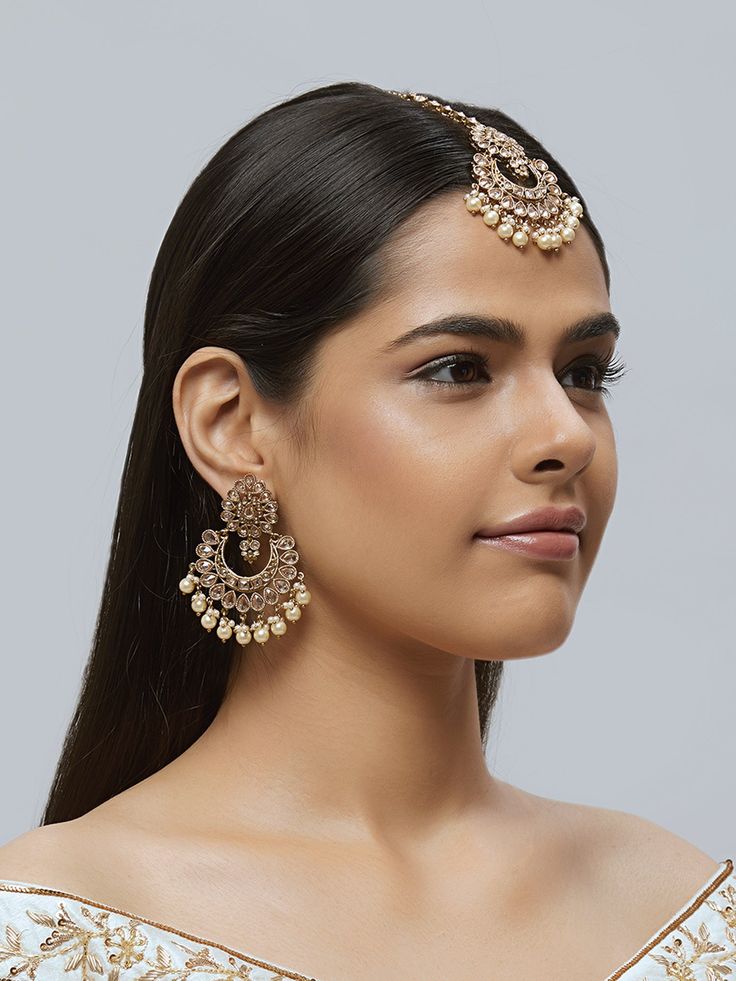 Beautiful kundan earrings with stones and pearls, plus matching mang tikka Traditional Indian Jewelry: Slight Color variations are possible due to lighting and photography. If you are interested in purchasing this item and have any additional questions about this item, please feel free to email us at nazranaanj@gmail.com. For faster responses, call us at 732-283-1808 or WhatsApp us at 609-852-9922 Care instructionsKeep Jewelry away from direct heat, water, perfumes, deodorants and other strong - Kundan Chandbalis With Pearl Drop For Reception, Temple Jewelry Style Danglers With Stone Work For Reception, Reception Temple Jewelry Danglers With Stone Work, Kundan Danglers With Stone Work For Reception, Diwali Kundan Chandelier Earrings With Pearl Drop, Kundan Temple Jewelry Danglers For Reception, Diwali Kundan Pearl Earrings With Stone Work, Pearl Drop Chandbali Earrings For Wedding, Kundan Bridal Earrings For Diwali Reception