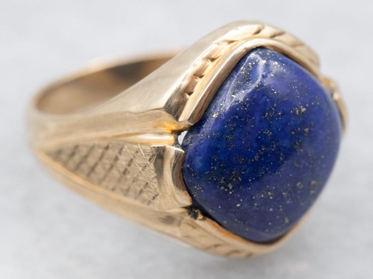 "This yellow gold mounting compliments the lapis beautifully! Flecks of gold glitter across the stone, complimented by the warm yellow gold. This ring is ready for a night out, and sized for everyday wear.  Metal: 10K Yellow Gold Gem: Lapis 4.58 Carats Gem Measurements: 10.8 mm, Square Cushion Cut Ring Size: 5.75 Marks: \"MJW 10K\" Stamped on the inside band To view a video of this piece check out the link below: https://vimeo.com/846050361 SKU #: A25954 Each piece has been identified and graded by a Graduate Gemologist who has been certified by the Gemological Institute of America (GIA). We have six brick-and-mortar storefronts in Maine, Massachusetts, and New Hampshire and have been in business for over 25 years! Please visit our Shop's About Page or our website for more information abou Lapis Ring, Cushion Cut Ring, Warm Yellow, Yellow Gold Ring, Ring Gold, Cocktail Ring, Gold Gold, Cushion Cut, Yellow Gold Rings