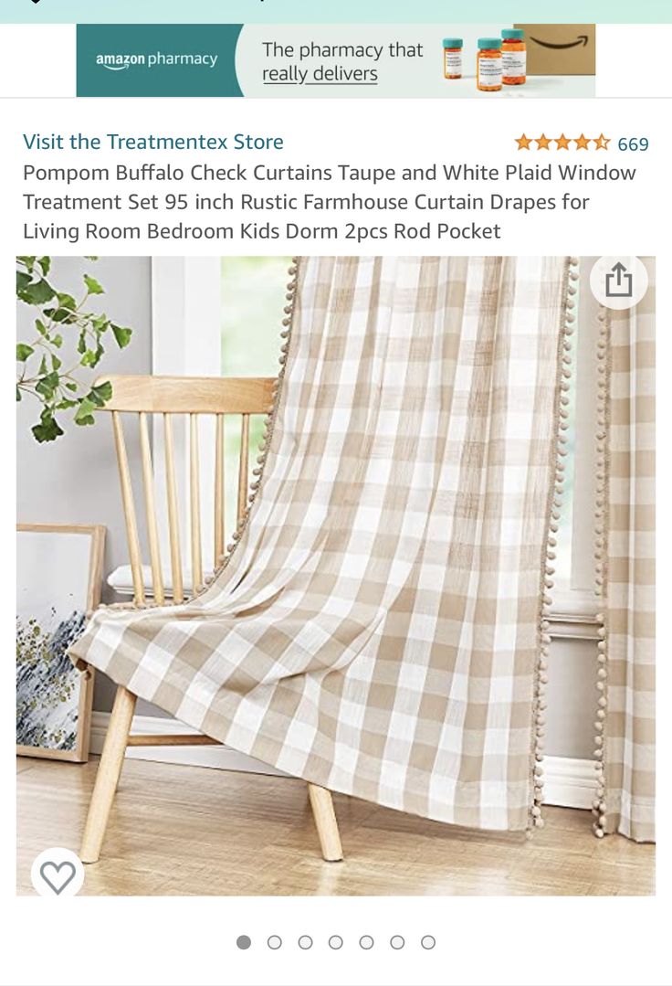 a chair sitting in front of a window covered with a plaid blanket and curtains next to a potted plant