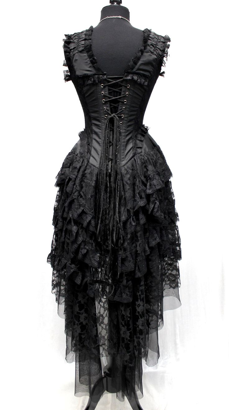 A beautiful french showgirl's corset dress made in black brocade and black lace. A brocade corset top edged all over in rich black lace. Decorative satin ribbon laces up the front with heavy duty corset lace-up in the back. The top has heavy steel boning on the front sides and back. A dramatic four layered black lace skirt longer in the back and shorter in the front with satin lining underneath. Fabulous!! Sizes in this dress: Size 22 = chest 32" waist 23" hips 33" Size 24 = chest 34", waist 24" Fitted Lace Corset Dress With Lace Bodice, Halloween Party Lace Corset Dress, Halloween Lace Corset Dress For Party, Halloween Lace Fitted Corset Dress, Black Lace Corset Dress For Halloween, Black Lace Dress With Lace-up Back, Lace Corset Dress With Boned Bodice, Black Party Corset With Lace-up Back, Steampunk Black Corset Dress For Costume