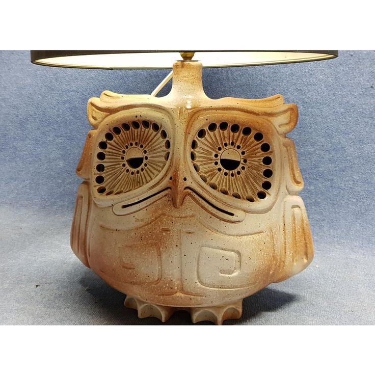 an owl shaped lamp with two eyes on it's head and a light shade