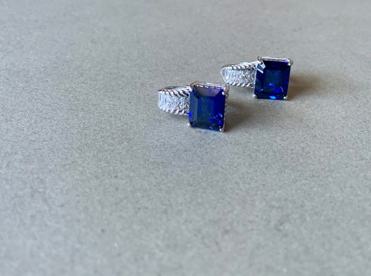 This gorgeous pair of vintage earrings feature sapphire and cubic zirconia stones set in sterling silver. They are made by designer Judith Ripka and are 2x1cm. There is a matching set of earrings with rubies instead of sapphires listed in my shop, and if you are interested in purchasing both, please message me prior to purchase for a discount. Blue Emerald Cut Earrings For Formal Occasions, Luxury Lab-created Sapphire Earrings For Formal Occasions, Luxury Lab-created Sapphire Earrings For Formal Events, Silver Sapphire Earrings With Diamond Accents, Sapphire Earrings With 17 Jewels For Gift, Sapphire Earrings With Multiple Jewels, Classic Formal Earrings With Accent Stones, Silver Tanzanite Earrings For Anniversary, Silver Earrings With Diamond Accents And Lab-created Sapphire