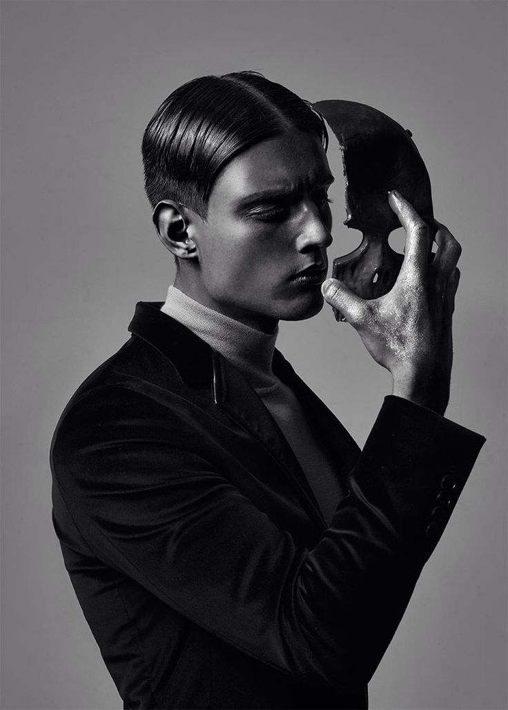 black and white photograph of a man holding a skull