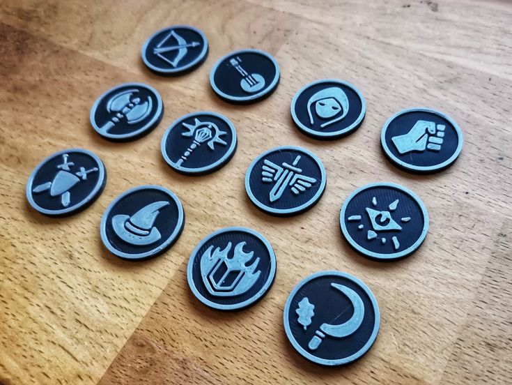 eight buttons with different symbols on them sitting on a table