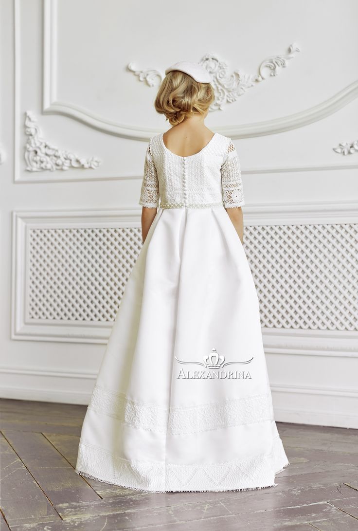 Elegant dress with lace decoration for true ladies. The designer outfit in a milky shade. The bodice with short sleeves is decorated with handmade lace trim. The waistline is slightly raised and highlighted by a decorative pearl belt. A straight skirt at the waist is gathered in large opposite folds, fringe along the bottom. The decor is two stripes of lace. #flowergirldress #princessdress #communiondress Tulle Cape, Pearl Belt, Holy Communion Dresses, Designer Outfit, First Communion Dress, First Communion Dresses, Lace Decor, Communion Dresses, Handmade Lace