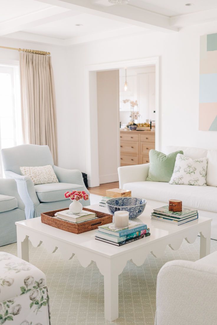 See inside Sunset Lane, our latest coastal traditional interior design project. This traditional grand millennial interior design living room features preppy furniture like this scallop edge coffee table and muted colored furniture. See the project here and explore our traditional home decor shop today!