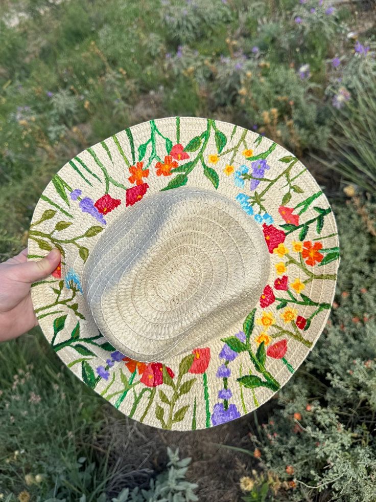 Hand painted straw hat perfect to express yourself with western flare in the summertime heat.  *100% Hand painted with Acrylic paint *Universal size fit with 24-inch circumference *flexible hat brim to suit your style Follow my Instagram @rollinsmokeboutique or facebook www.facebook.com/share/AQACWT7BRhNPEYtY/?mibextid=LQQJ4d to see some more products 🤍 Thanks for your order! Artisan Panama Hat For Spring Beach, Whimsical Brimmed Sun Hat For Summer, Spring Bohemian Fedora With Curved Brim, Artisan Panama Hat For Beach In Spring, Bohemian Spring Fedora With Curved Brim, Summer Hat With Floral Print For Vacation, Summer Beach Hats With Floral Print, Beach Sun Hat With Floral Print And Curved Brim, Spring Beach Sun Hat With Floral Print