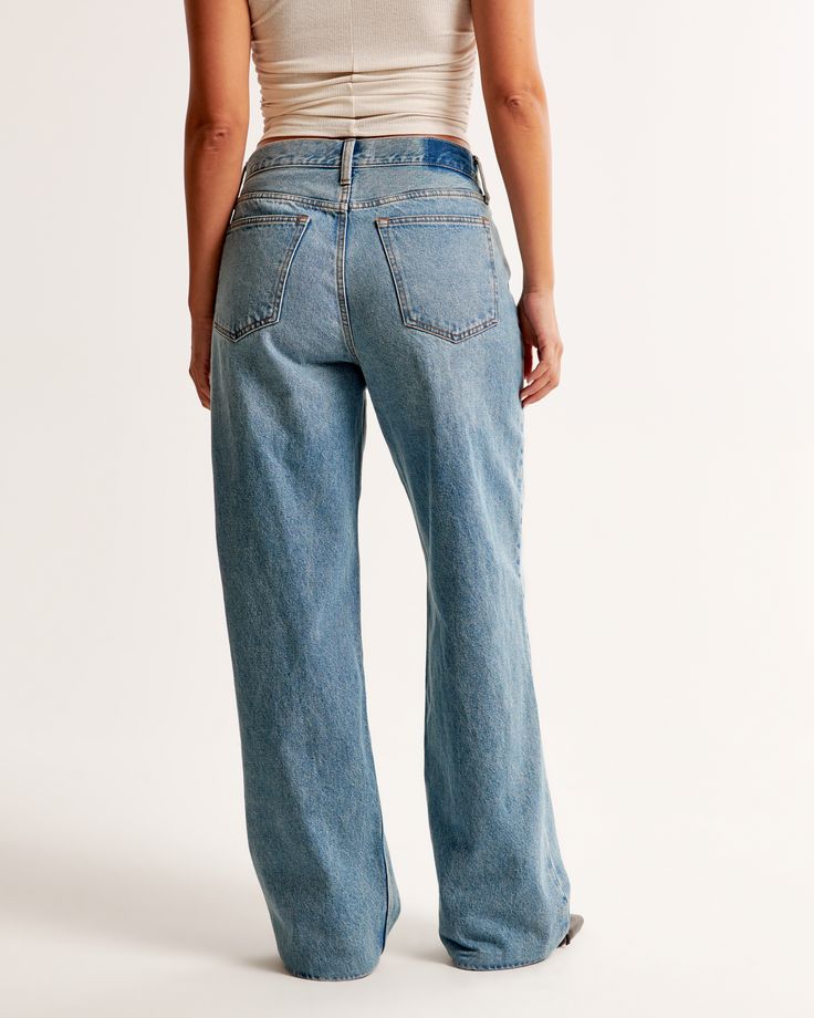 Our new Curve Love mid rise slouchy jeans in a medium wash with a clean hem. This fit features a 9.5” mid rise, is slouchy at the waist and hips, and eases through the thigh into a baggy, full-length leg shape. The viral fit that eliminates waist gap: Curve Love features additional room through the hip and thigh for curve-hugging comfort. We recommend buying your true size for a slouchier fit. Size down for a closer fit. This jean is made from our heavyweight rigid denim, a super soft authentic cotton fabric with no stretch. Slouchy Jeans, Women's Bottoms, Abercrombie Fitch, Medium Size, Womens Bottoms, Mid Rise, Gap, Full Length, Cotton Fabric